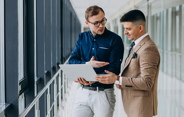 Two Man Discussing Over Laptop